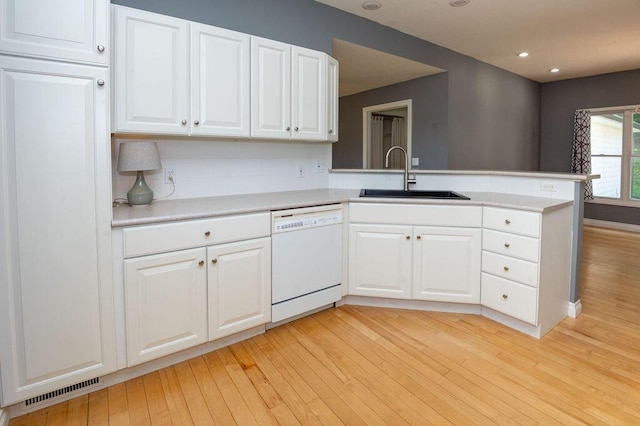 5412 Blackberry Ln, Coloma, MI 49038 - kitchen featuring dishwasher, a peninsula, light wood-style floors, white cabinets, and light countertops