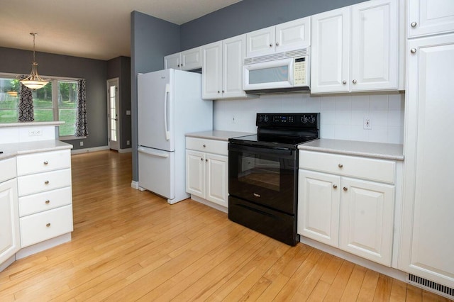 5412 Blackberry Ln, Coloma, MI 49038 - kitchen featuring white appliances, light wood-style floors, backsplash, and light countertops
