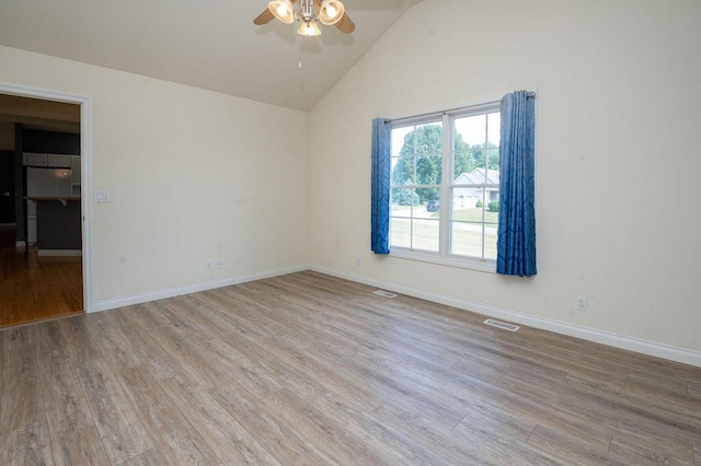 5412 Blackberry Ln, Coloma, MI 49038 - empty room featuring a ceiling fan, wood finished floors, and high vaulted ceiling