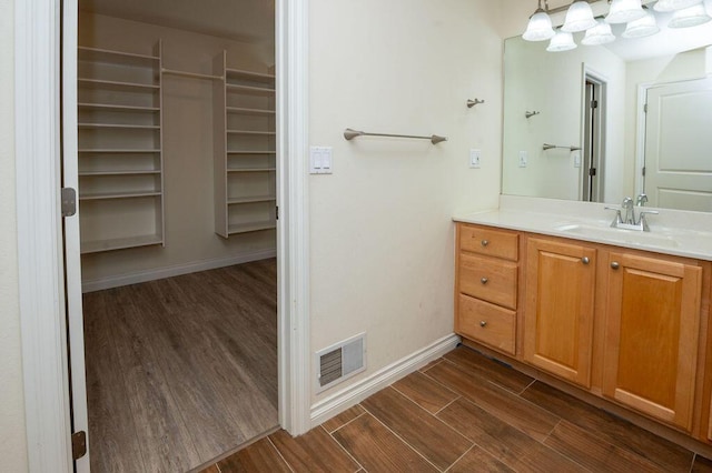 5412 Blackberry Ln, Coloma, MI 49038 - bathroom featuring wood finished floors and vanity