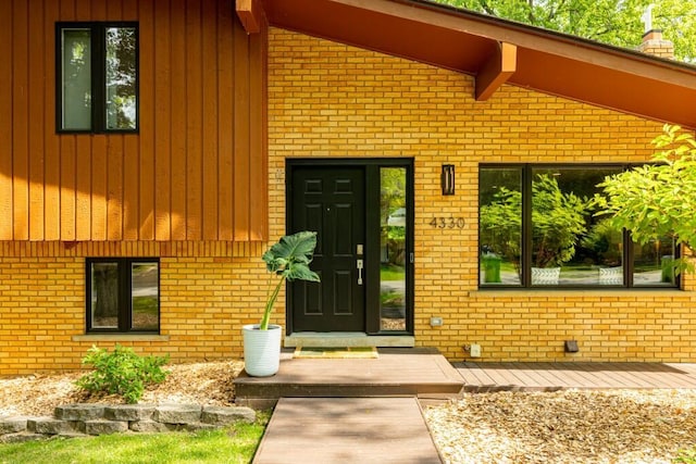 4330 Eastgate Dr, Ann Arbor, MI 48103 - doorway to property with brick siding and a chimney