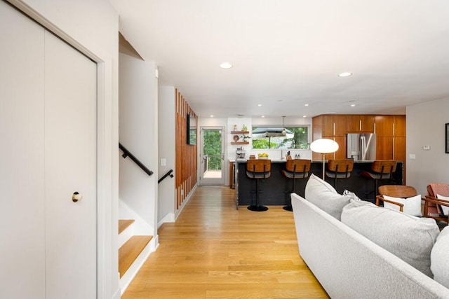 4330 Eastgate Dr, Ann Arbor, MI 48103 - living area featuring light wood finished floors, recessed lighting, and stairway