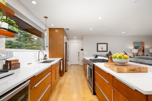 4330 Eastgate Dr, Ann Arbor, MI 48103 - kitchen with appliances with stainless steel finishes, light wood-style flooring, beverage cooler, brown cabinets, and light countertops