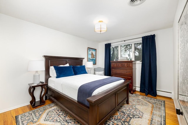 4330 Eastgate Dr, Ann Arbor, MI 48103 - bedroom featuring baseboard heating and light wood-style floors