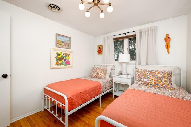 4330 Eastgate Dr, Ann Arbor, MI 48103 - bedroom featuring a chandelier and wood finished floors