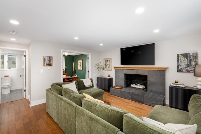 4330 Eastgate Dr, Ann Arbor, MI 48103 - living room featuring wood finished floors, recessed lighting, and a tiled fireplace