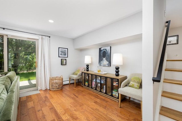 4330 Eastgate Dr, Ann Arbor, MI 48103 - living area with baseboard heating, light wood finished floors, stairs, and recessed lighting