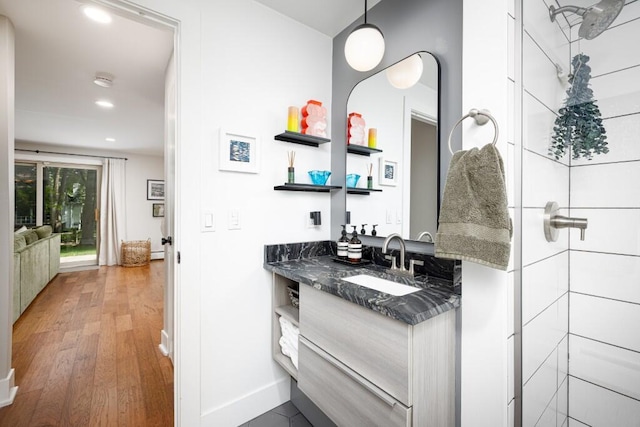 4330 Eastgate Dr, Ann Arbor, MI 48103 - bathroom featuring vanity, wood finished floors, recessed lighting, and a shower