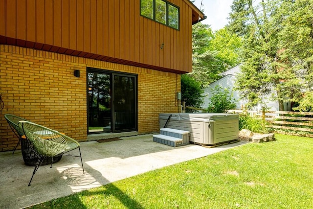 4330 Eastgate Dr, Ann Arbor, MI 48103 - back of house with a hot tub, brick siding, and a patio area