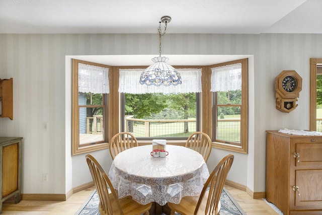 7272 E M 113, Kingsley, MI 49649 - dining space with wallpapered walls, light wood-style flooring, and plenty of natural light