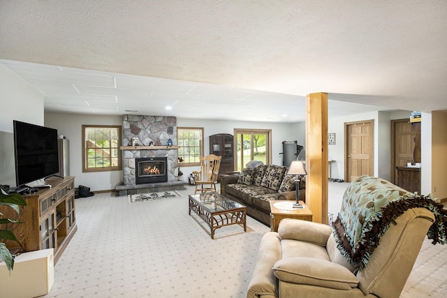7272 E M 113, Kingsley, MI 49649 - living area featuring carpet floors, a fireplace, and a textured ceiling