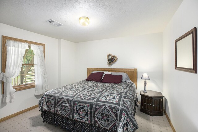7272 E M 113, Kingsley, MI 49649 - bedroom with carpet floors and a textured ceiling