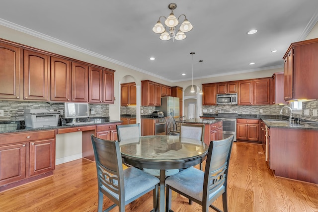 50501 Elmwood Ct, Plymouth, MI 48170 - kitchen featuring stainless steel appliances, light wood-style floors, backsplash, a center island, and decorative light fixtures