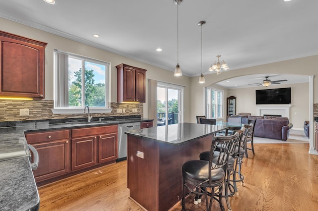 50501 Elmwood Ct, Plymouth, MI 48170 - kitchen with dishwasher, a breakfast bar area, a ceiling fan, backsplash, and a center island