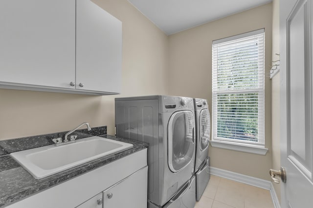 50501 Elmwood Ct, Plymouth, MI 48170 - laundry area featuring separate washer and dryer, cabinet space, and light tile patterned floors