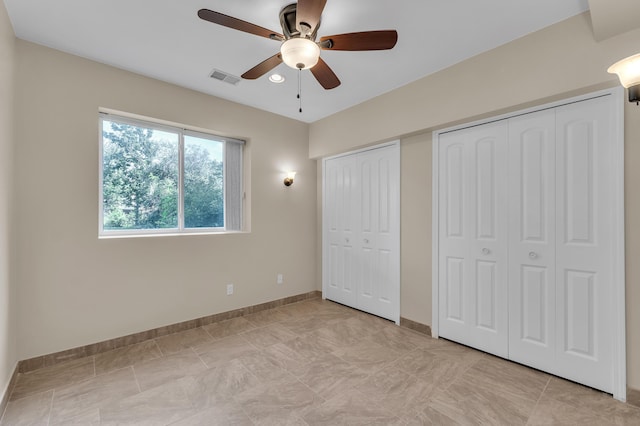 50501 Elmwood Ct, Plymouth, MI 48170 - unfurnished bedroom featuring two closets and ceiling fan