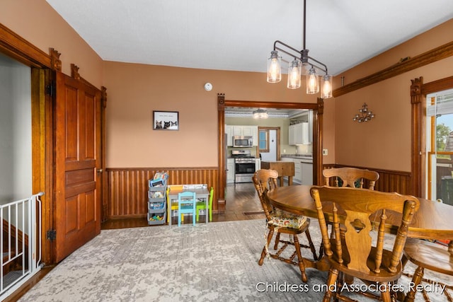 13872 Hastings Rd, Freeport, MI 49325 - dining room featuring a wainscoted wall and wood finished floors