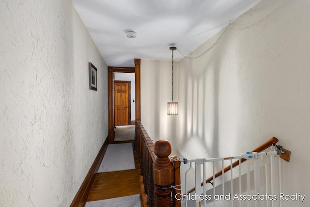 13872 Hastings Rd, Freeport, MI 49325 - corridor featuring an upstairs landing and a textured wall