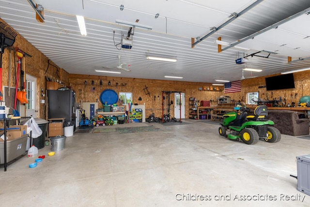 13872 Hastings Rd, Freeport, MI 49325 - garage with a workshop area and a garage door opener