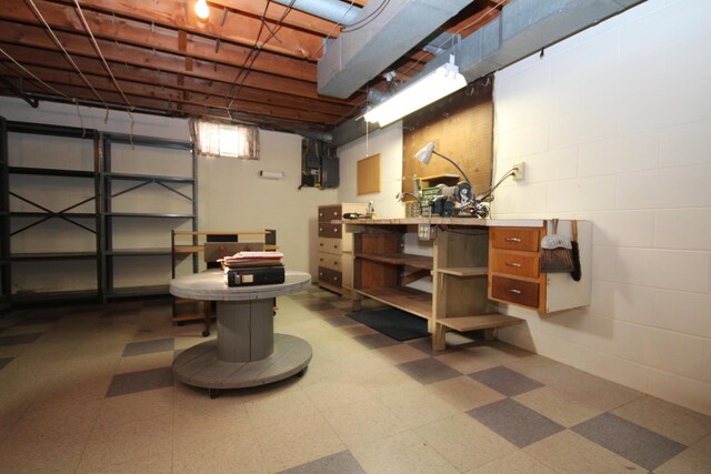 6426 Westchester St, Portage, MI 49024 - below grade area with tile patterned floors, concrete block wall, and a workshop area