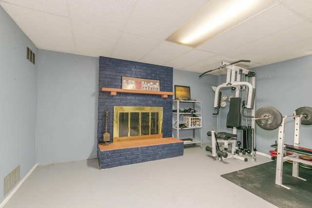 1736 Glenvale Dr SW, Wyoming, MI 49519 - workout room featuring a paneled ceiling and a brick fireplace