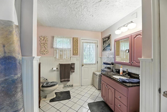8454 Stickles Rd, Three Oaks, MI 49128 - bathroom featuring wainscoting, tile patterned flooring, vanity, and a textured ceiling