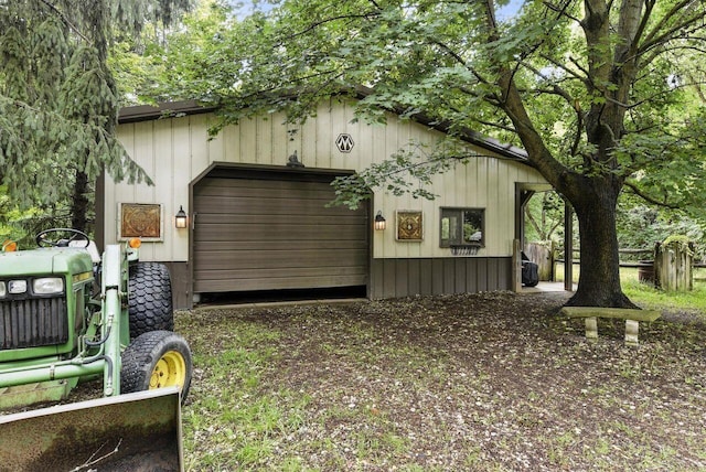 8454 Stickles Rd, Three Oaks, MI 49128 - view of side of home with an attached garage, an outdoor structure, and driveway