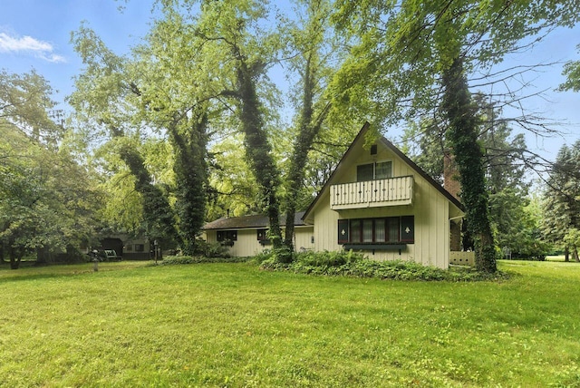 8454 Stickles Rd, Three Oaks, MI 49128 - view of front of property featuring a balcony and a front yard