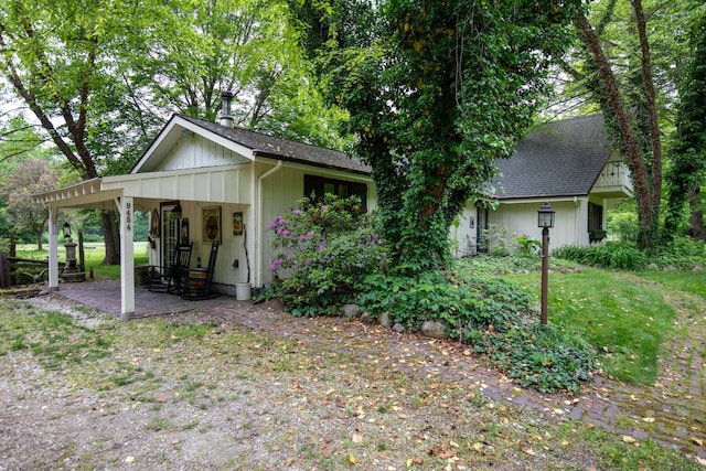 8454 Stickles Rd, Three Oaks, MI 49128 - view of side of home with roof with shingles and board and batten siding