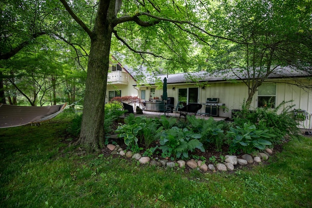 8454 Stickles Rd, Three Oaks, MI 49128 - back of property featuring board and batten siding, a patio area, and a yard