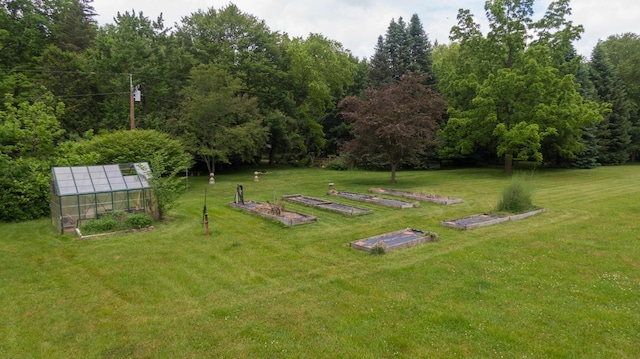 8454 Stickles Rd, Three Oaks, MI 49128 - view of green lawn with an exterior structure, a vegetable garden, and an outdoor structure