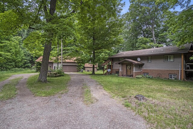 4424 Teal Ln, Newaygo, MI 49337 - view of front facade featuring an outbuilding, a front yard, and a garage