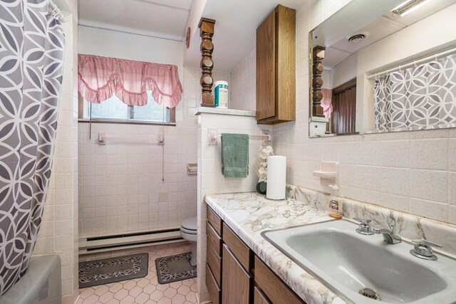 4424 Teal Ln, Newaygo, MI 49337 - full bath featuring a baseboard radiator, tile patterned flooring, vanity, tile walls, and shower / bathtub combination with curtain
