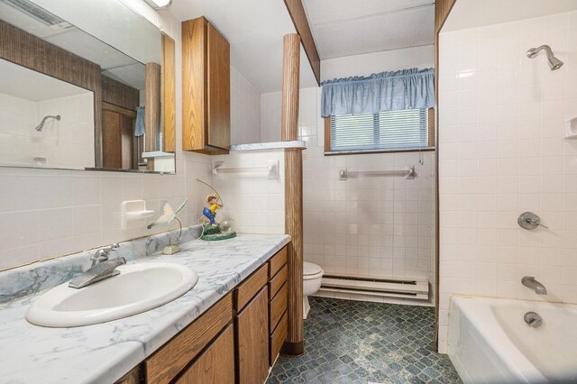 4424 Teal Ln, Newaygo, MI 49337 - bathroom with a baseboard radiator, tile patterned floors, vanity, tile walls, and shower / washtub combination