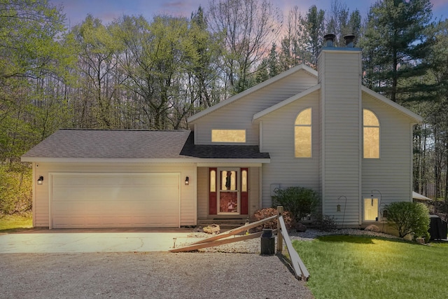 4792 Forest Vale Dr, Pierson, MI 49339 - view of front of home featuring concrete driveway, a chimney, a garage, a yard, and roof with shingles