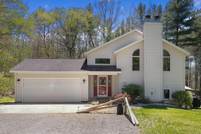4792 Forest Vale Dr, Pierson, MI 49339 - view of front of property with an attached garage, a chimney, concrete driveway, a front lawn, and a shingled roof