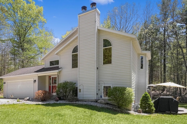 4792 Forest Vale Dr, Pierson, MI 49339 - view of front of property with an attached garage, a chimney, and a front lawn