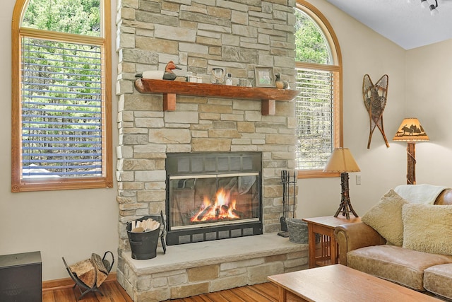 4792 Forest Vale Dr, Pierson, MI 49339 - living room with wood finished floors, a stone fireplace, and vaulted ceiling