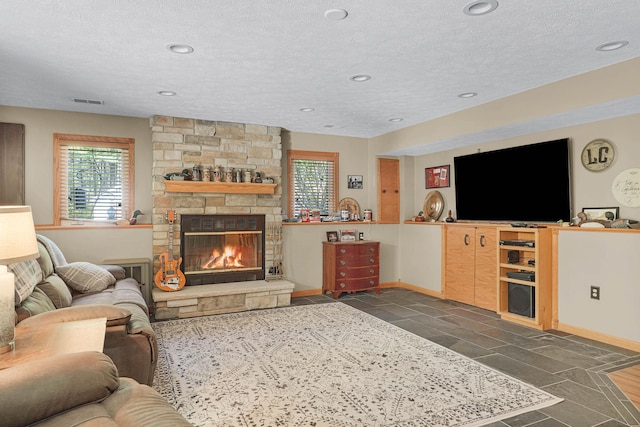 4792 Forest Vale Dr, Pierson, MI 49339 - living area with a textured ceiling, a fireplace, and recessed lighting