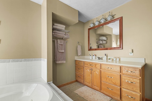 4792 Forest Vale Dr, Pierson, MI 49339 - full bathroom with a whirlpool tub, vanity, and a textured ceiling
