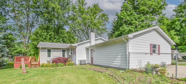 72 Branch Ave, Coldwater, MI 49036 - view of front of house featuring a chimney, a front yard, and a deck