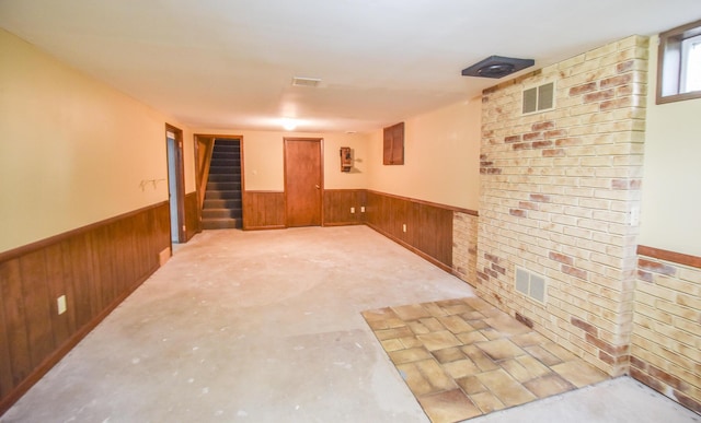 72 Branch Ave, Coldwater, MI 49036 - below grade area featuring a wainscoted wall, wood walls, and stairs
