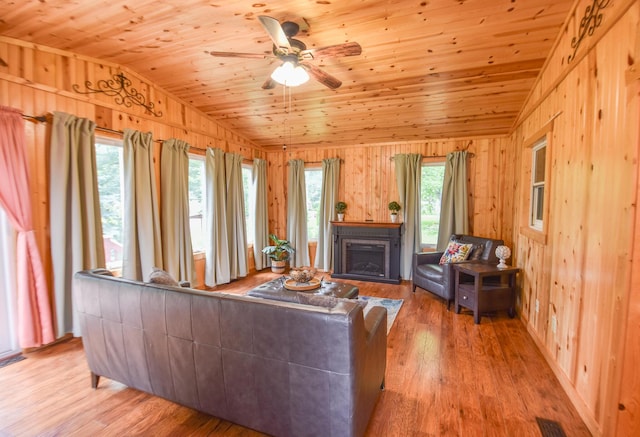 72 Branch Ave, Coldwater, MI 49036 - living room featuring vaulted ceiling, wooden walls, wood ceiling, ceiling fan, and light wood-style flooring
