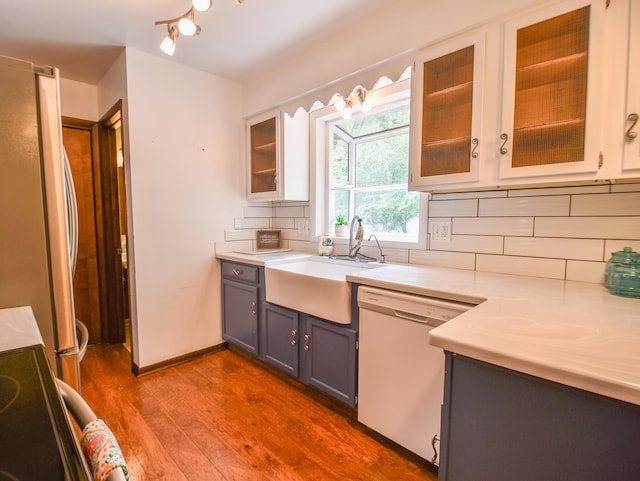 72 Branch Ave, Coldwater, MI 49036 - kitchen with white dishwasher, wood finished floors, freestanding refrigerator, light countertops, and gray cabinets