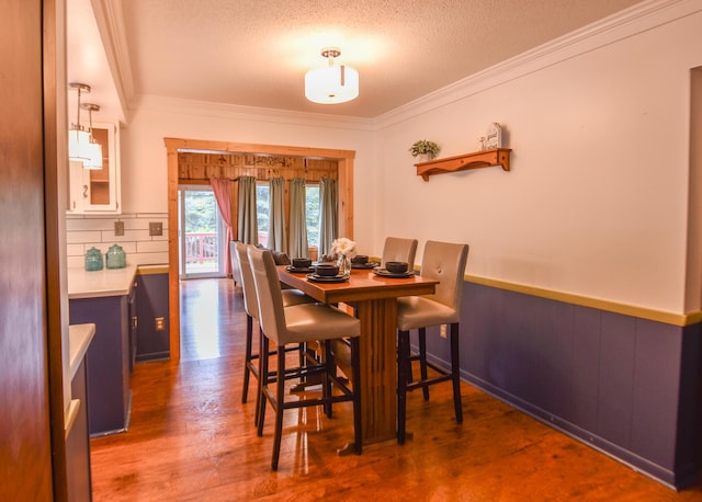 72 Branch Ave, Coldwater, MI 49036 - dining space with ornamental molding, wood finished floors, a textured ceiling, and wainscoting