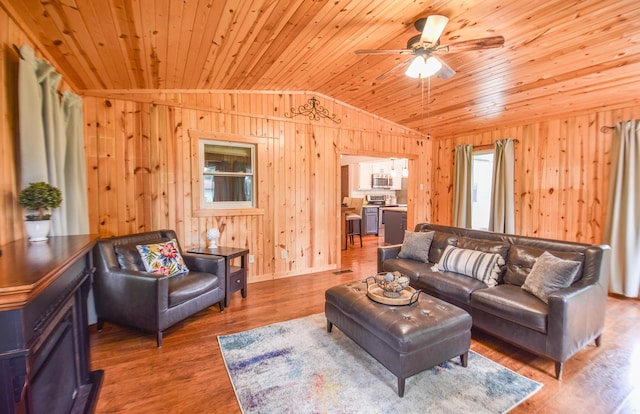 72 Branch Ave, Coldwater, MI 49036 - living room featuring vaulted ceiling, wooden ceiling, wooden walls, ceiling fan, and wood finished floors