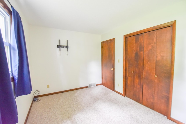 72 Branch Ave, Coldwater, MI 49036 - unfurnished bedroom featuring multiple windows, carpet, and a closet