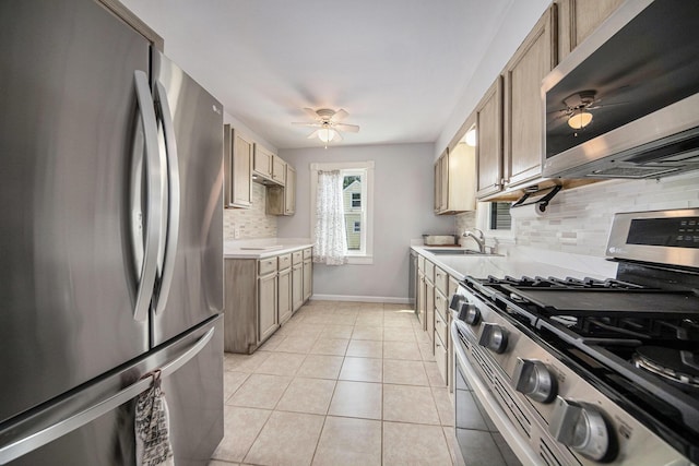 1836 W Argus Ct, Jackson, MI 49203 - kitchen with appliances with stainless steel finishes, a ceiling fan, light countertops, and backsplash
