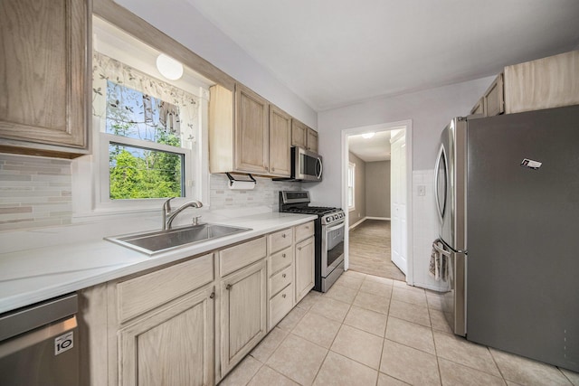 1836 W Argus Ct, Jackson, MI 49203 - kitchen with stainless steel appliances, light brown cabinetry, light countertops, light tile patterned flooring, and decorative backsplash