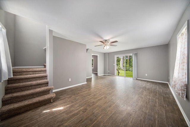1836 W Argus Ct, Jackson, MI 49203 - unfurnished living room featuring dark wood finished floors, a ceiling fan, and stairway